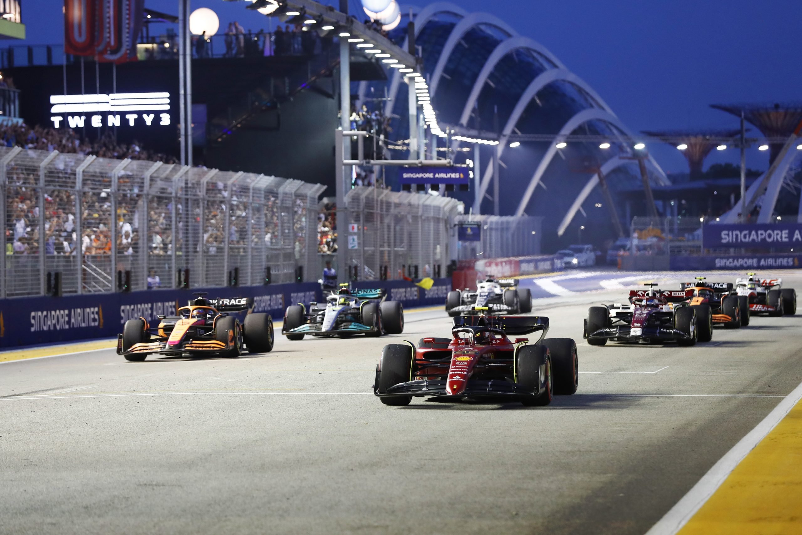 F1 cars roaring down the Pit Straight during a session over the race weekend scaled 1