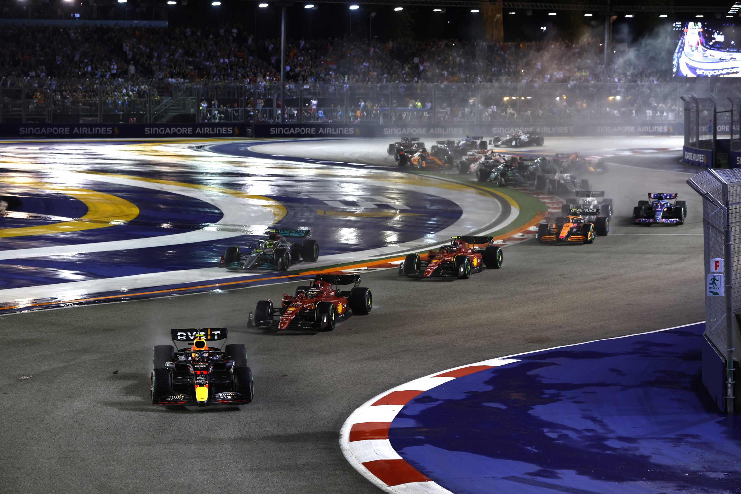 Red Bulls Sergio Perez leads the race in the opening lap as the cars tackle the initial turns of the Marina Bay Street Circuit scaled 1